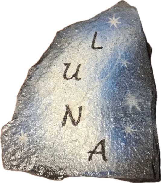 A slate stone painted in a night-sky blue with white stars, with the name Luna running down it.